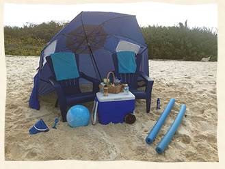 Beach umbrella, chairs, food and cooler for a relaxing time on the beach after your wedding.