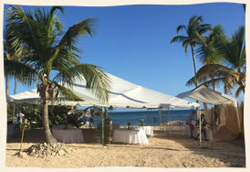 Beach wedding reception under tent - caribbean.
