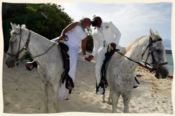 Bride and groom on horseback after getting married at Lindquist Beach.