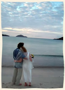 Wedding couple gazing out to sea at beautfful Magens Bay, Caribbean