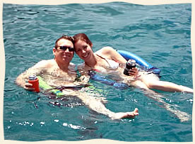Couple floating in marriatal bliss Caribbean Sea